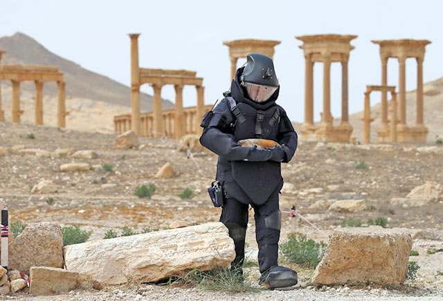 In this April 8 photo provided by Russian defence ministry’s press service, a Russian deminer checks for mines in the Palmyra ancient ruins (AP photo)
