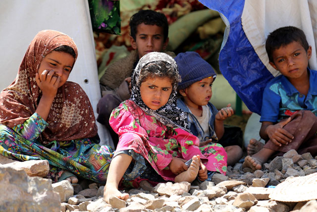 Yemeni children sit in front of a tent built on stone-covered ground near the Mokha port on the Red Sea in Taez, Yemen, on Wednesday (Anadolu Agency photo)
