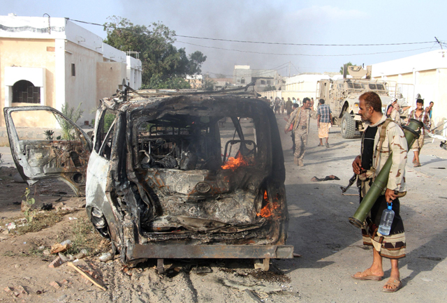 A Yemeni man looks at a burning vehicle following a reported suicide car bombing in Huta, the capital of the southern province of Lahj, a bastion of Al Qaeda extremists, on Monday (AFP photo)
