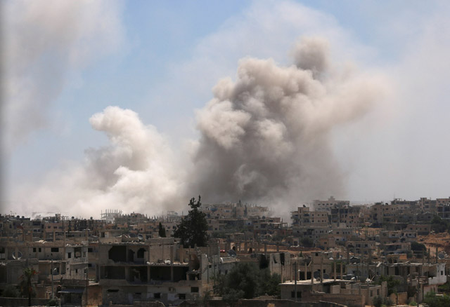 Smoke rises after shelling at a rebel-held part of the southern city of Deraa, Syria, on Monday (Reuters photo)
