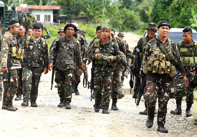 Philippine soldiers patrol a road at Pigkawayan, a farming town about 160 kilometres from Marawi, on north Cotabato, in the southern Philippine island of Mindanao, on Wednesday (AFP photo)