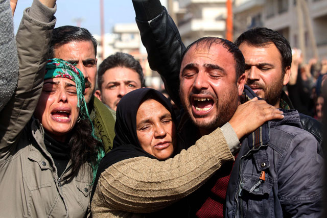 This photo taken on Saturday, in the town of Afrin, shows the mother (centre), brother (right) and sister (left) of the late 23-year-old YPJ fighter Barin Kobani, attending a mourning ceremony in her honour, after the YPJ and the Syrian Observatory for Human Rights accused Turkish-backed Syrian rebels of filming her mutilated dead body (AFP photo)