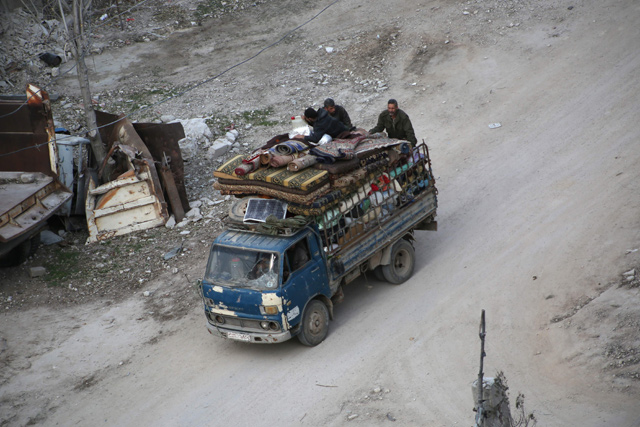 Syrian civilians carry their belongings on the back of a pickup truck as they flee following government bombardment on Kafr Batna in the besieged Eastern Ghouta region on the outskirts of the capital Damascus on Saturday (AFP photo)
