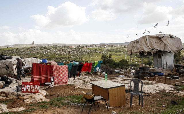 This photo taken on Tuesday shows a laundry washing line hung between a tent and a mobile structure where a Palestinian family lives with others near the Israeli settlement of Susya, who have been warned to evacuate due to being in the so-called  ‘Area C’ in the occupied West Bank near Yatta south of the city of Hebron (AFP photo)
