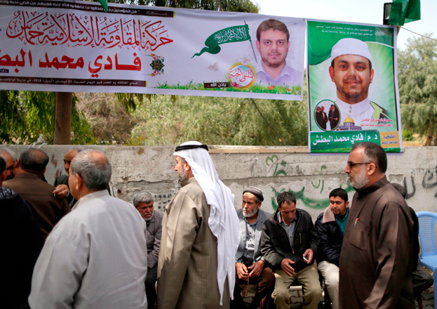 Palestinians gather in mourning outside the family home of 35-year-old professor and Hamas member Fadi Mohammad Al Batsh, who was killed early in the day in Malaysia, in Jabalia in the northern Gaza strip, on Saturday (AFP photo)