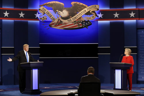 Republican presidential nominee Donald Trump answers a question as Democratic presidential nominee Hillary Clinton listens during the presidential debate at Hofstra University in Hempstead, NY, Monday (AP photo)
