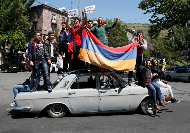 Supporters of Armenian opposition leader Nikol Pashinyan drive a car during a rally in Yerevan, Armenia, on Wednesday (Reuters photo)