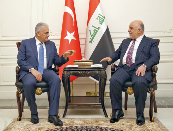 Iraq’s Prime Minister Haider Al Abadi (right) and Turkish Prime Minister Binali Yildirim speak during a meeting in Baghdad, Iraq, on Saturday (AP photo)