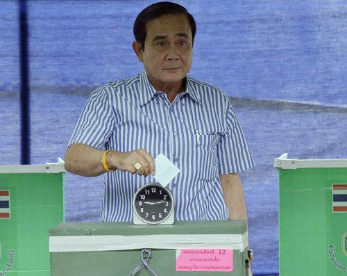Thailand's Prime Minister Prayut Chan-O-Cha poses as he casts his vote in a referendum on a new constitution at a polling station in Bangkok, Thailand, on Sunday (AP photo)