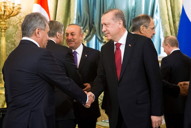This file photo taken on March 10 shows Turkey’s President Recep Tayyip Erdogan (right), shaking hands with Russian Defence Minister Sergei Shoigu following a meeting at the Kremlin in Moscow (AFP photo)