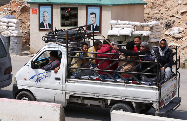 A vehicle carrying Jaish Al Islam fighters and their family members, evacuated from the Eastern Ghouta town of Douma, arrives at the Wafideen camp on Thursday (AFP photo)