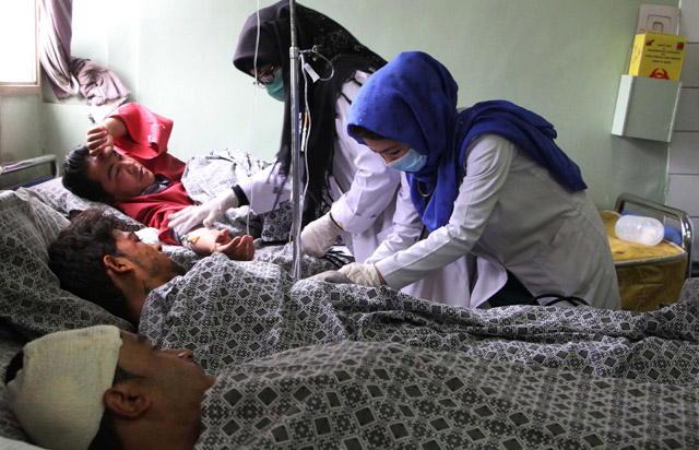 Afghan people receive treatments after a suicide attack that targeted NATO convoy in Kabul, Afghanistan, on Wednesday (Anadolu Agency photo)