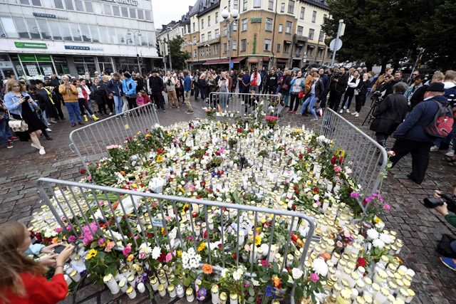Candles and flowers have been left at the makeshift memorial for the victims of Friday's stabbings at the Turku Market Square, Finland, on Saturday (AFP photo)