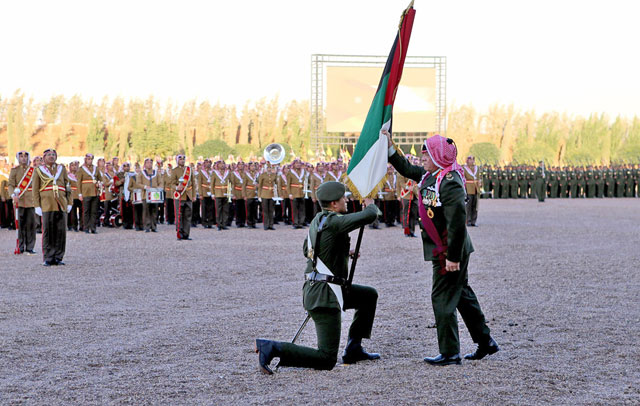 His Majesty King Abdullah presents the Great Arab Revolt Flag to an army battalion during the annual Flag Parade in Amman on Thursday (Photo courtesy of Royal Court)