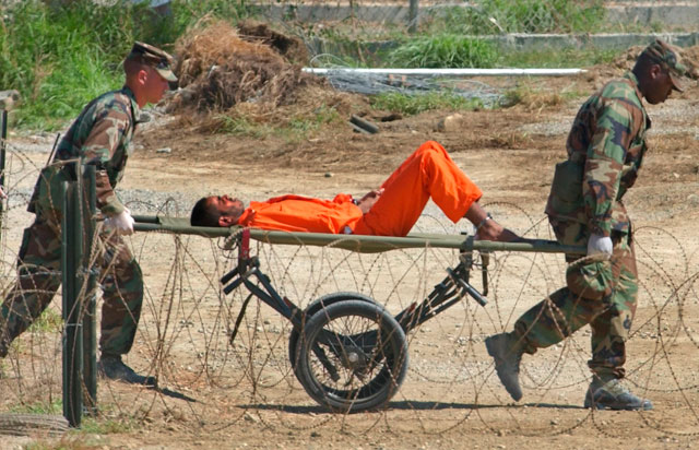 In this February 2, 2002 file photo, a detainee from Afghanistan is carried on a stretcher before being interrogated by military officials at the detention facility Camp X-Ray on Guantanamo Bay US Naval Base in Cuba (AP photo)
