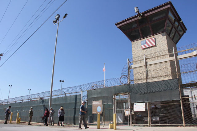 Poeple walk past a guard tower outside the fencing of Camp 5 at the US Military’s Prison in Guantanamo Bay, Cuba, on Thursday (AFP photo)