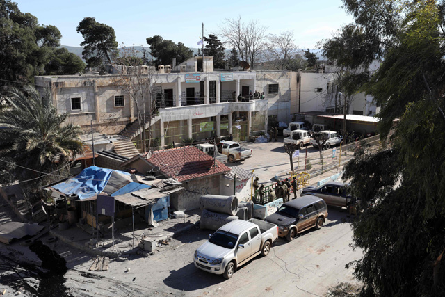 Turkish-backed Syrian rebels gather in a local council building in the town of Jandairis from Kurdish forces in Syria's Afrin region, near the Turkish border, on Friday (AFP photo)