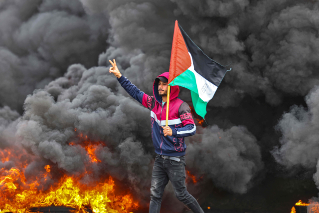 Palestinian youths burn tyres during a protest near the Israel-Gaza border, east of Jabalia refugee camp, on Thursday (AFP photo)