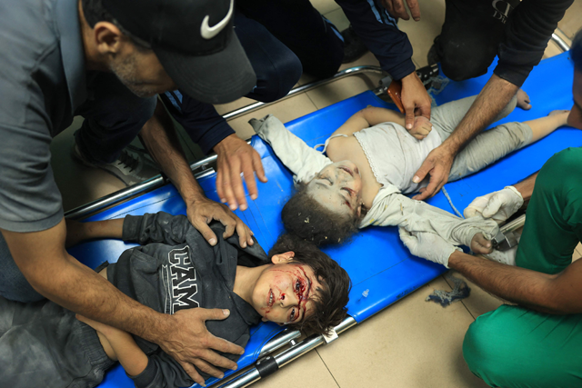 Two young Palestinian children lie on a stretcher at the  Al Aqsa hospital following the Israeli bombardment of in Deir Al Balah, in the central Gaza Strip on Wednesday (AFP photo)