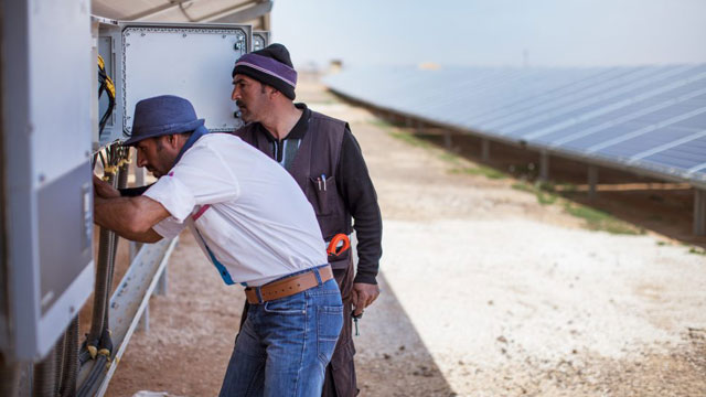 Syrian refugees are seen working on the maintenance of temporary homes provided by a joint private-public sector partnership in the Azraq camp (Photo courtesy of IKEA Foundation)
