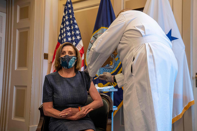 Speaker of the House Nancy Pelosi (D-CA) receives a COVID-19 vaccination shot by doctor Brian Monahan, attending physician Congress of the United States in her office in Washington, DC, on Friday (AFP photo)
