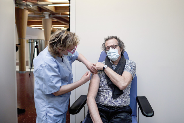 A man is vaccinated with an injection of the Moderna COVID-19 vaccine at the first COVID-19 vaccination centre in Belgium on Tuesday in Brussels, amid the crisis linked with the COVID-19 pandemic caused by the novel coronavirus (AFP photo)