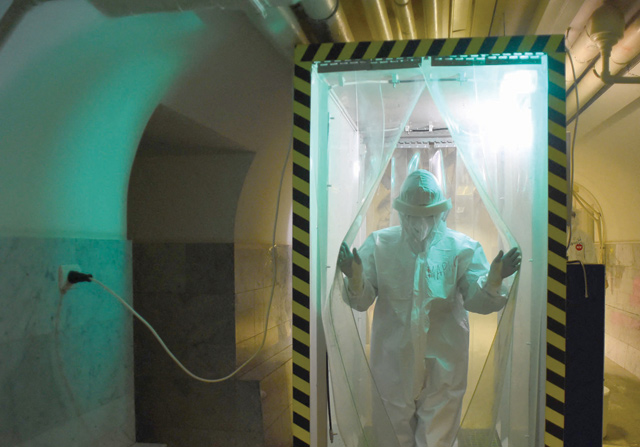 A medical worker wearing a protective equipment PPE walks through a disinfection cabin at the COVID-19 unit of the Mariinsky Hospital in Saint Petersburg on Wednesday (AFP photo)