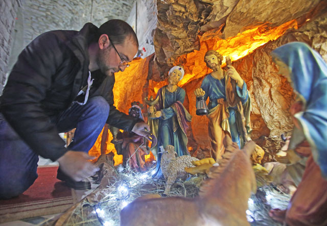 A Syrian man decorates the Saint Mary Church of the Holy Belt (Umm Al Zennar Church) with a Christmas nativity scene in the Christian-majority neighbourhood of Hamidiyeh in the old city of Homs on December 17 (AFP photo)