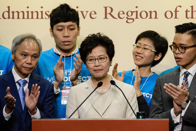 Hong Kong's new Chief Executive Carrie Lam (centre) reacts at a press conference after she won the Hong Kong chief executive election in Hong Kong on Sunday (AFP photo)
