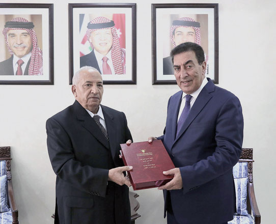 House Speaker Atef Tarawneh receives the 2017 human rights report from President of the National Centre for Human Rights’ Board of Trustees Mohammad Bakhit in Amman on Monday (Petra photo)