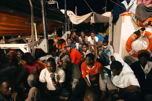 This handout photo taken on Monday by German NGO ‘Mission Lifeline’ off the coast of Malta shows migrants sitting on board the Lifeline ship (AFP photo)