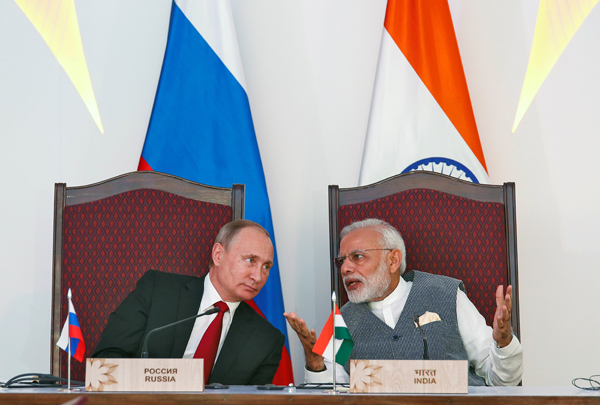 India’s Prime Minister Narendra Modi (right) speaks with Russian President Vladimir Putin during an exchange of agreements event after the India-Russia Annual Summit in Benaulim, in the western state of Goa, India, on Saturday (Reuters photo)