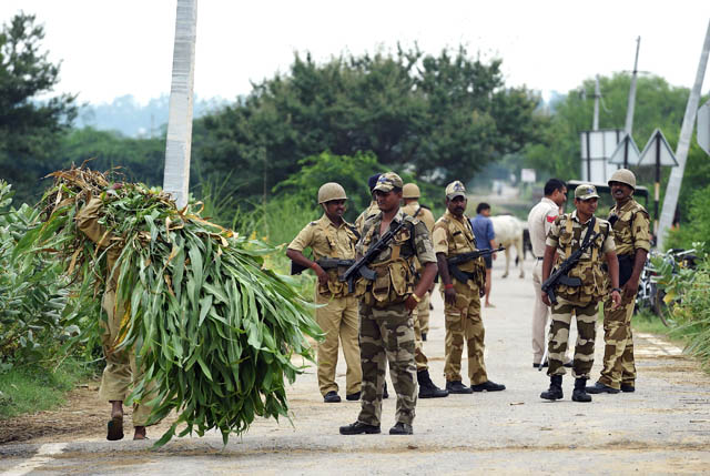 Indian security personnel stand guard along a road near Sonariya jail in Rohtak on Monday (AFP photo)