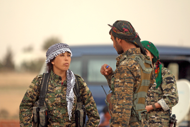 Rojda Felat, commander of a US-backed operation by Kurdish and Arab fighters to capture the Syrian city of Raqqa, stands with fellow fighters near the Tabaqa Dam, west of Raqqa, Syria, on Thursday (Reuters photo)