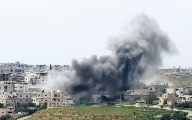 Smoke rises after the warplanes belonging to the Syrian Regime Forces bombed the Menshiyye neighbourhood as Syrian military opposition advance towards the centre of Daraa, Syria, on Monday (Anadolu Agency photo)