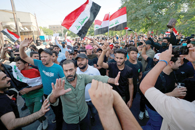 Iraqi supporters of pro-Iran Hashed Al Shaabi alliance take part in a protest denouncing the results of Iraq's parliamentary elections in Baghdad on Tuesday (AFP photo)