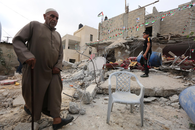 Palestinians collect their belongings and usable household goods after the Israeli authority demolished their houses in Kobar town of Ramallah, West Bank, on Wednesday (Anadolu Agency photo)