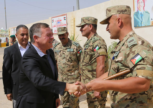 His Majesty King Abdullah is received by officers as he visits an army battalion on Monday, where he met with top brass (Photo courtesy of Royal Court)