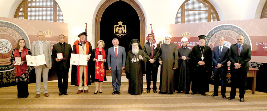 His Majesty King Abdullah poses for a group photo with winners of World Interfaith Harmony Week competition in Amman on Tuesday (Photo courtesy of Royal Court)