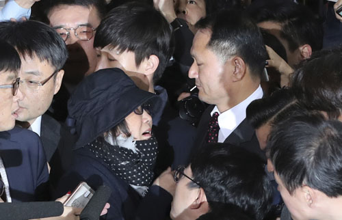 Choi Soon-sil (centre left), a cult leader's daughter with a decades-long connection to President Park Geun-hye, is surrounded by prosecutor's officers and media upon her arrival at the Seoul Central District Prosecutors' Office in Seoul, South Korea, on Monday (AP photo)