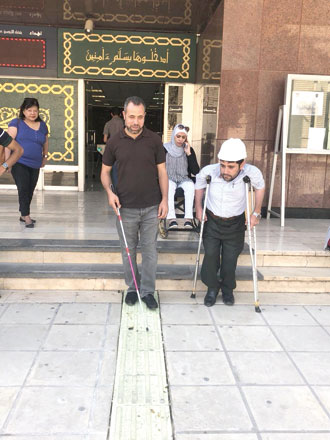 A visually impaired man using the new lanes at UJ during the launching event (Photo courtesy of Hadeel Abu Soufeh)