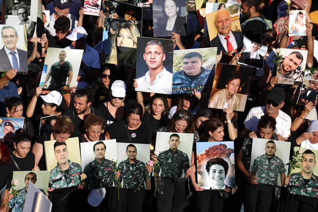 Protesters lift placards depicting the victims of the 2020 Beirut port blast during a march near the Lebanese capital's harbour on Friday marking the third anniversary of the deadly explosion (AFP photo)