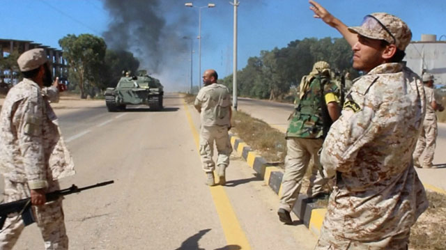Soldiers from a force aligned with Libya’s new unity government walk along a road during an advance on the eastern and southern outskirts of the Daesh stronghold of Sirte, in this still image taken from video, on Thursday (Reuters photo)