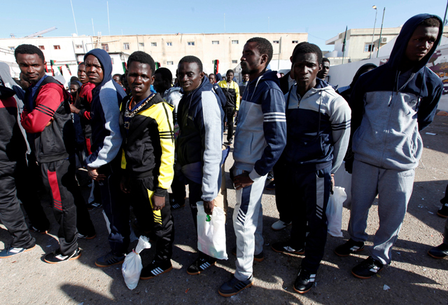 Illegal African migrants stand in a line as they wait before their voluntary return to their countries in Tripoli, Libya, on Tuesday (Reuters photo)