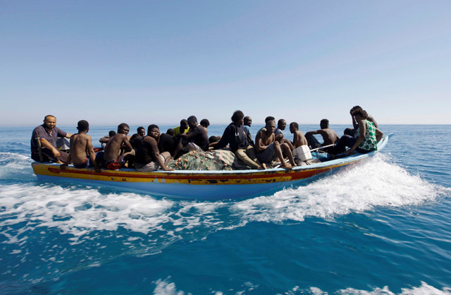 Migrants ride in a boat after they were rescued by Libyan coastguard off the coast of Gharaboli, east of Tripoli, Libya, on Saturday (Reuters photo)