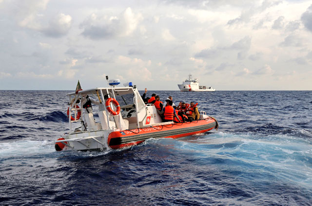 An Italian coastguard’s rigid-hulled inflatable boat transfers Libyan migrants from the migrant search and rescue vessel MV Seefuchs of the German NGO Sea-Eye, to the Italian coastguard vessel Dattilo (rear) in international waters off the coast of Libya, Monday (Reuters photo)