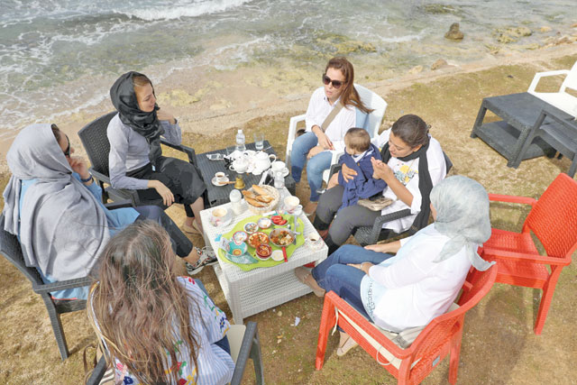 Women sit at a cafe on a beach in Tripoli, Libya, on Saturday (Reuters photo)