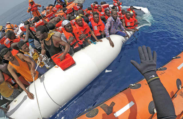 Migrants on a dinghy are rescued by ‘Save the Children’ NGO crew from the ship Vos Hestia in the Mediterranean sea off Libya coast, June 17 (Reuters photo)
