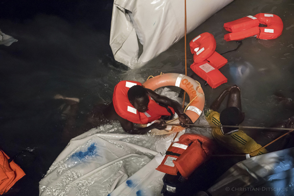 This October 21 photo, provided by Sea-Watch aid group, shows the rescue of migrants off the Libyan coast in the Mediterranean Sea (AP photo)