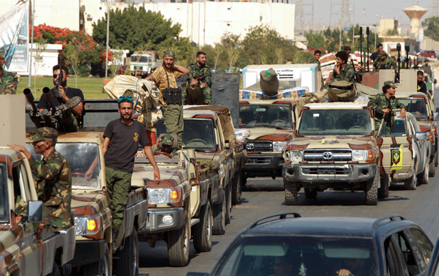 Members of the self-proclaimed eastern Libyan National Army (LNA) special forces gather in the city of Benghazi, on their way to reportedly back up fellow LNA fighters on the frontline, facing forces loyal to the UN-recognised Government of National Accord, on Thursday (AFP photo)
